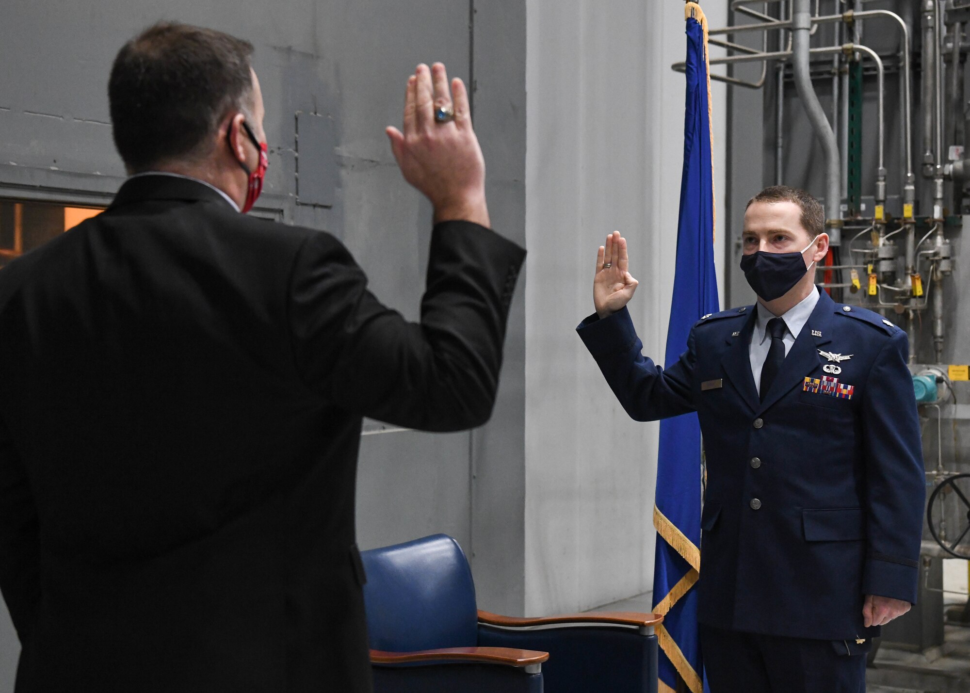 Brian Knauf, retired Air Force lieutenant colonel, left, administers the oath of office to his brother, newly-promoted Lt. Col. Michael Knauf during a promotion ceremony, March 1, 2021, at Arnold Air Force Base, Tenn. (U.S. Air Force photo by Jill Pickett)