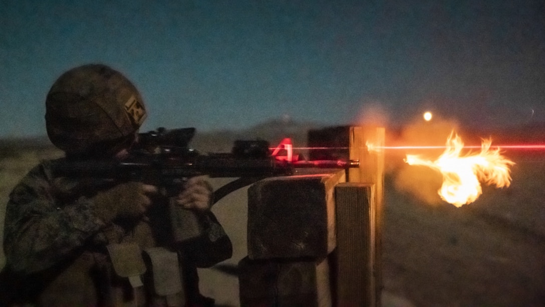 Marine with Combat Logistics Battalion 11, 11th Marine Expeditionary Unit, fires an M4 carbine at targets during a low-light engagement as part of Realistic Urban Training exercise at Marine Corps Air Ground Combat Center Twentynine Palms, California, Feb. 25, 2021.