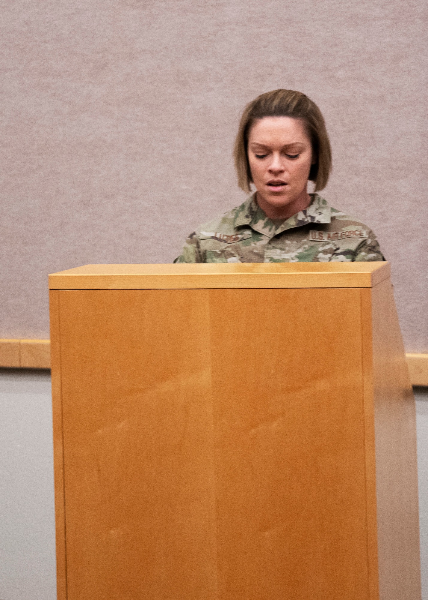 Tech. Sgt. Briana Lutes, event coordinator for the Senior Non-commissioned Officer Induction Ceremony, opens the event with a speech on Whiteman Air Force Base, Missouri, March 6, 2021. The ceremony recognizes Airmen who have recently been promoted into the first tier of the SNCO ranks. (U.S. Air National Guard photo by Airman 1st Class Whitney Erhart)