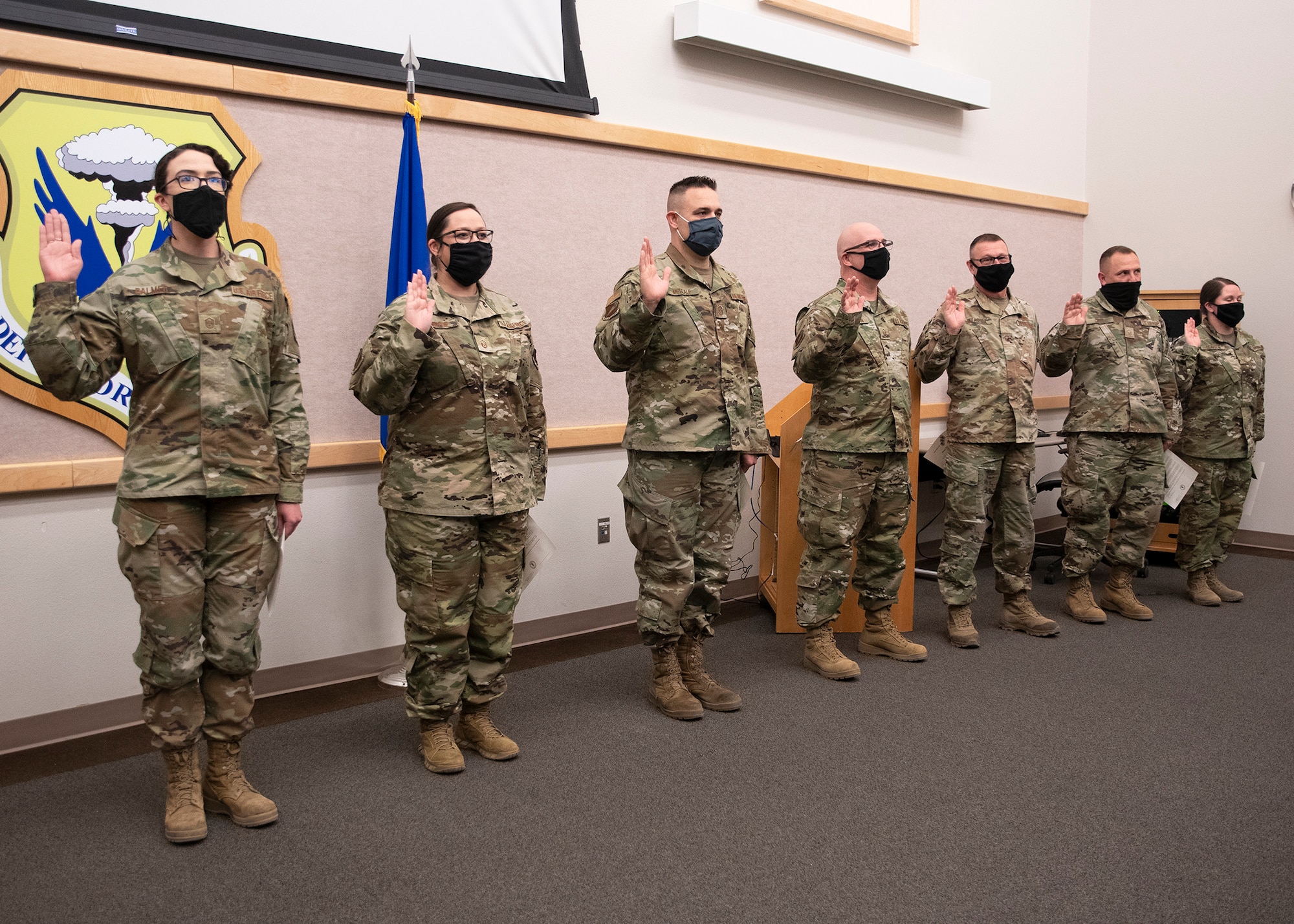 Air National Guard members with the 131st Bomb Wing raise their right hand and recite the the Senior Non-commissioned Officer (SNCO) pledge during an SNCO Induction Ceremony at Whiteman Air Force Base, Missouri, March 9, 2021. The ceremony recognizes Airmen who have recently been promoted into the first tier of the SNCO ranks. (U.S. Air National Guard photo by Airman 1st Class Whitney Erhart)