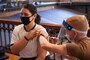 Midshipman 4th Class Meg Babbitt receives the COVID-19 vaccine, which is currently voluntary for active duty members, including midshipmen, while it is in an Emergency Use Authorization status.