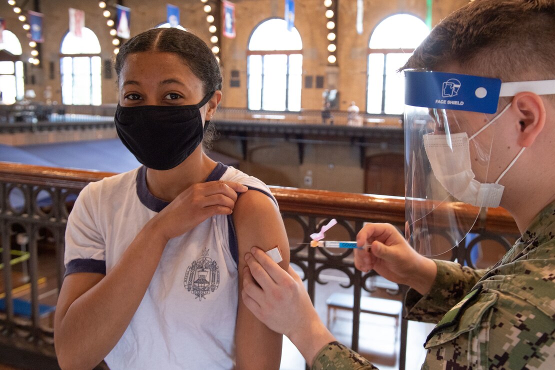 Midshipman 1st Class Madeleine Cooke receives the COVID-19 vaccine, which is currently voluntary for active duty members, including midshipmen, while it is in an Emergency Use Authorization status.