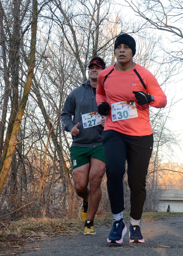 DLA Disposition Services Acting Director Army Col. Franyate Taylor, front, and Doug Mulvaney, run on the River trail south of the Hart-Dole-Inouye Federal Center March 12 as part of their 3.14 miles in observance of Pi Day.