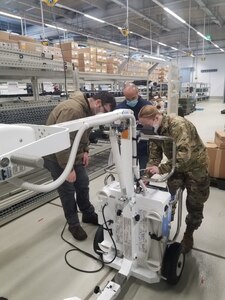 Pfc. Danielle Fincannon, right, a Soldier assigned to the U.S. Army Medical Materiel Center-Europe, receives training on a portable digital radiography system from biomedical equipment technicians from the U.S. Army Medical Materiel Agency on Feb. 9 at the Army Prepositioned Stocks site in Dulmen, Germany. (Master Sgt. Hyun Kim)