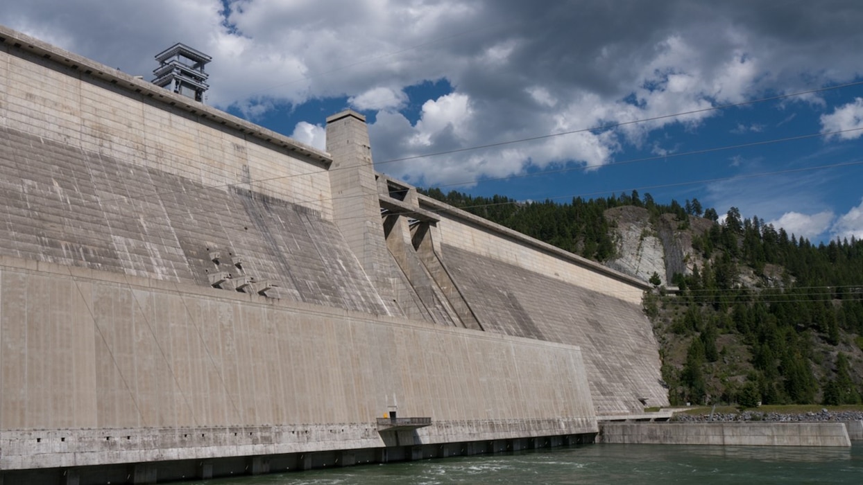 Libby Dam, located on the Kootenai River near Libby, MT, is 422 feet tall and 3,055 feet long.  Construction began in 1966 with 4 generators completed by 1975 and a fifth placed online in 1984 for a total capacity of 525 megawatts.  The dam was built with 7.6 million tons of concrete and holds back the water of the Kootenai River forming Lake Koocanusa.   