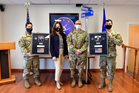 (Left to right) Tech. Sgt. Horace Salik, 75th Operations Support Squadron, Lorene Kamalu, 75th OSS honorary commander, Lt Col. Joseph Michaels, 75th OSS commander, and Staff Sgt. Joshua Caldwell, 75th OSS, display memorial plaques March 3, 2021, at Hill Air Force Base, Utah.  The tributes to Maj. Walter “David” Gray and Capt. Nathan “Nate” Nylander who lost their lives in the service of our country while giving aid to fellow injured service members during the War in Afghanistan will be displayed in the 75th Operations Support Squadron Heritage Room. (U.S. Air Force photo by Todd Cromar)