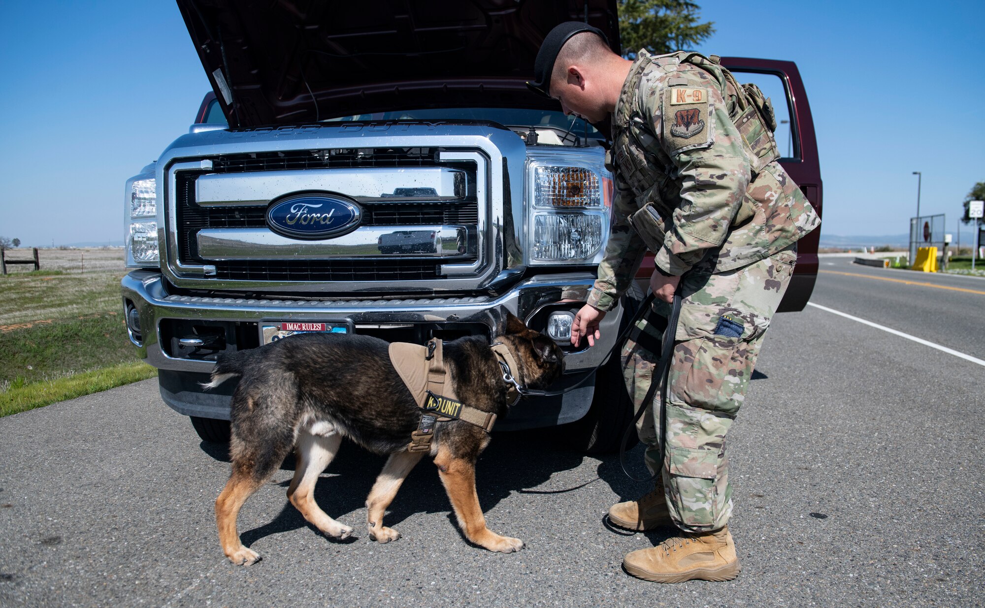 Staff Sgt. Jason Herrier, 9th Security Forces Squadron (SFS) military working dog (MWD) handler and Bady 2, 9th SFS MWD search a vehicle leaving Beale Air Force Base.
