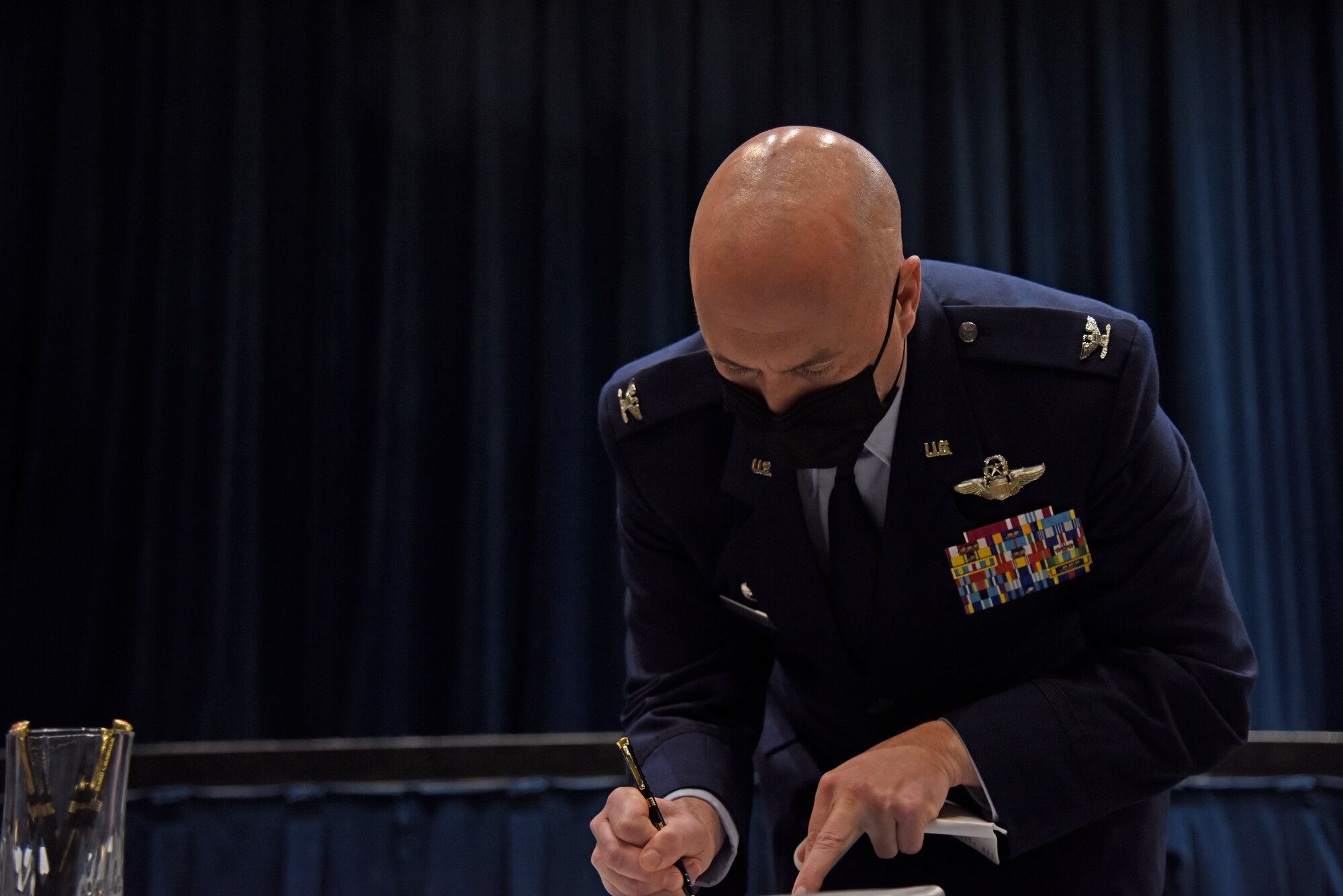 U.S. Air Force Col. Cassius T. Bentley III, 92nd Air Refueling Wing Commander, signs the intergovernmental agreement for a the first-ever Indoor Small Arms Range Partnership on March 15, 2021, Airway Heights, Washington. The signing event culminated an 8-year effort to forge a partnership between the three entities, Fairchild Air Force Base, the Spokane County Sheriff’s Office, and the Spokane County Board of Commissioners. (U.S. Air Force photo by Staff Sgt. Jesenia Landaverde)