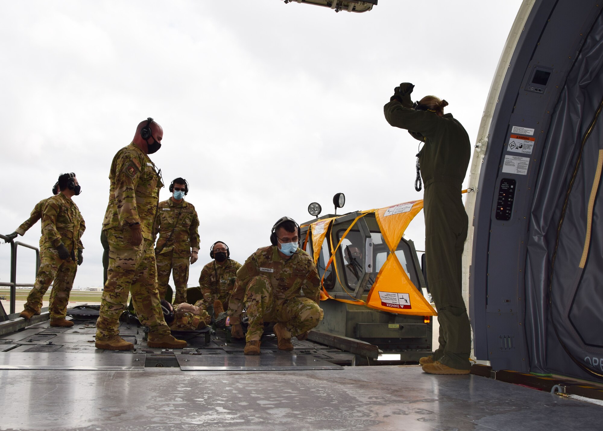 Reserve Citizen Airmen with the 433rd Aeromedical Evacuation Squadron prepare to carry a simulated patient on a litter into a KC-46A Pegasus during initial qualification training at Joint Base San Antonio-Lackland, Texas, March 9, 2021. When not serving in a military capacity, many of these personnel also work in the civilian healthcare industry. (U.S. Air Force photo by Tech. Sgt. Iram Carmona)