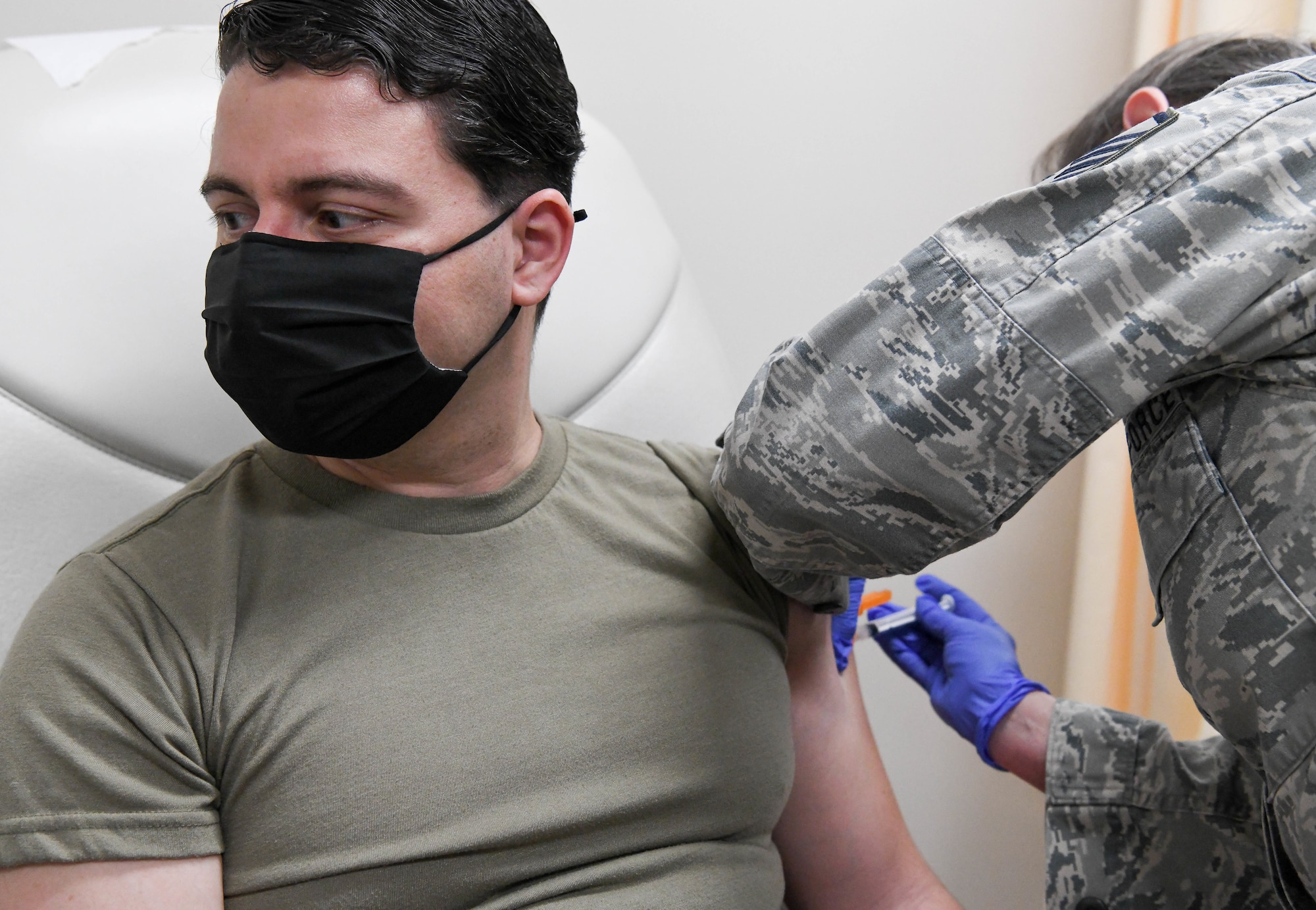 Master Sgt. Marti Stanley with the Tennessee Air National Guard administers a COVID-19 vaccine to Capt. Christopher Fernandez, an Arnold Engineering Development Complex team member, at Arnold Air Force Base, Tenn., Feb. 23, 2021, at the Medical Aid Station on base. (U.S. Air Force photo by Jill Pickett)