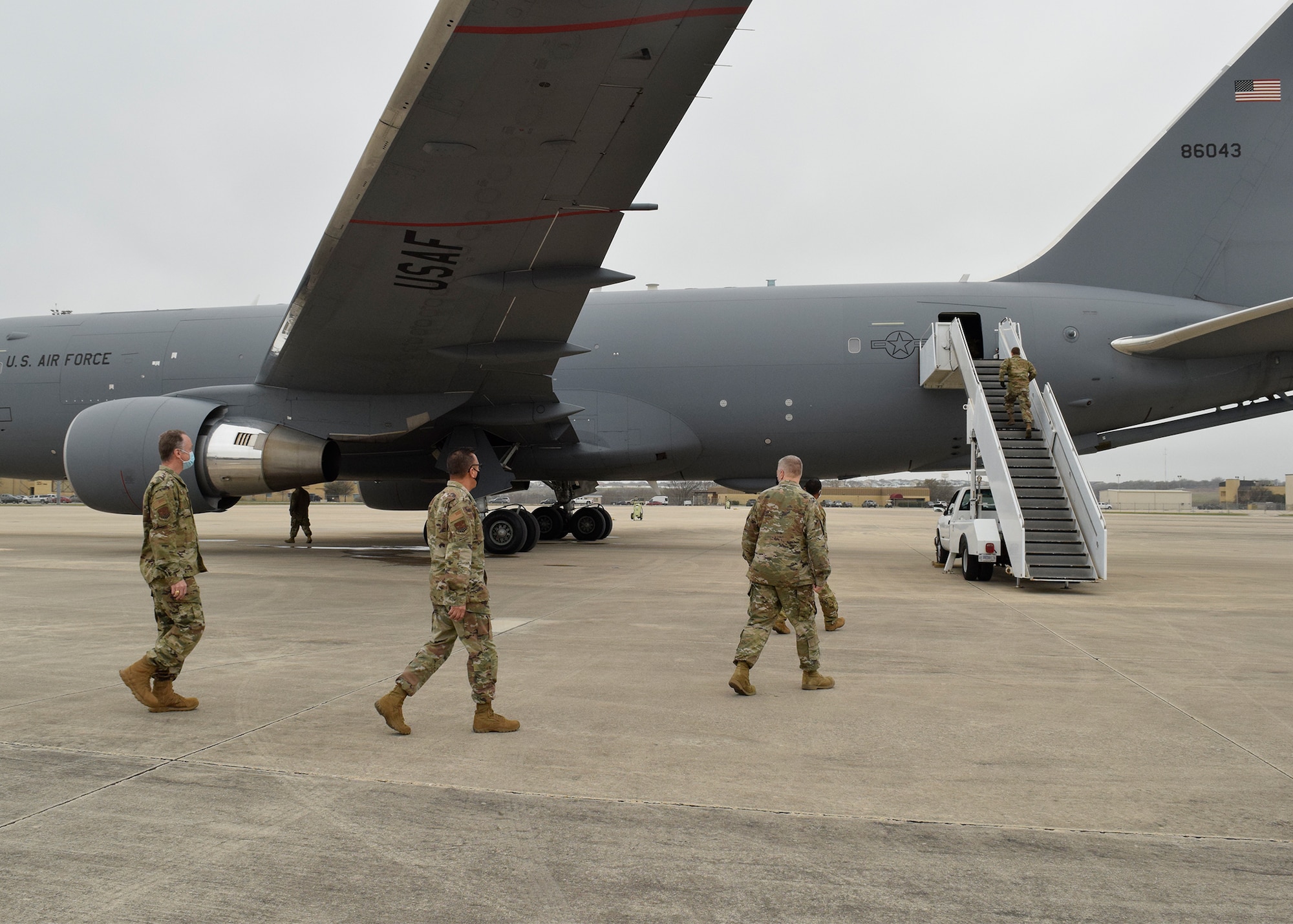 433rd Airlift Wing leaders prepare to board a KC-46A Pegasus to observe 433rd Aeromedical Evacuation Squadron medical personnel conducting initial qualification training March 9, 2021, at Joint Base San Antonio-Lackland, Texas. The KC-46 is a multi-mission capable aircraft, which can refuel other military aircraft in-flight and transport passengers, patients and cargo. (U.S. Air Force photo by Senior Airman Brittany Wich)