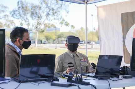 NORCO, Calif. (March 2, 2021) vRotors president Neil Malhotra instructs Lt. Col. Brandon Newell of Marine Corps Installations West on drone flight during a 5G Demo Day test event at Norco College. The Navy's Inland Empire Tech Bridge, anchored by NSWC Corona, networked with the college to host the event, during which vRotors demonstrated technologies for the Marine Corps for a National Security Innovation Network 5G Starts prize challenge. (U.S. Navy photo by Nathan Fite/RELEASED)