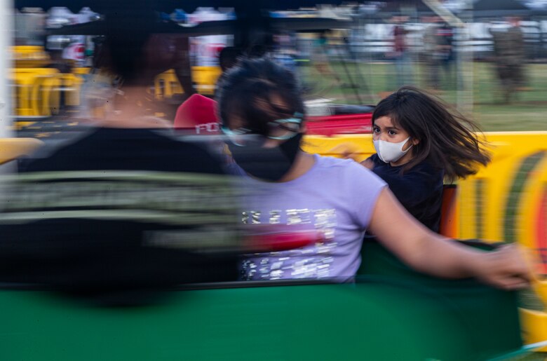 U.S. service members and their families participate in a pirate ship ride during the 2021 Hansen Festival on Camp Hansen, Okinawa, Japan, March 13, 2021. The festival is hosted annually to encourage camaraderie within the U.S. military community through an assortment of food, fun-filled activities and live performances. (U.S. Marine Corps photo by Lance Cpl. Alex Fairchild)