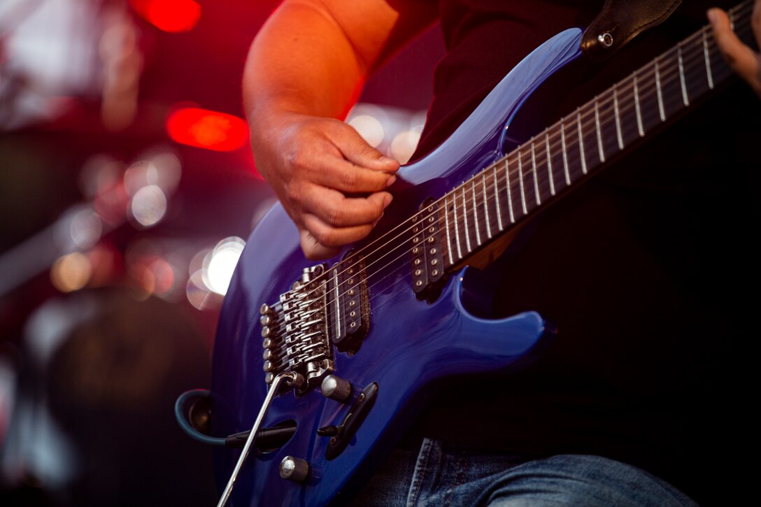 Jun Oshiro, the guitarist with the Koza City Rockers, a rock and roll tribute band, performs during the 2021 Hansen Festival on Camp Hansen, Okinawa, Japan, March 13, 2021. The festival is hosted annually to encourage camaraderie within the U.S. military community through an assortment of food, fun-filled activities and live performances. (U.S. Marine Corps photo by Lance Cpl. Alex Fairchild)