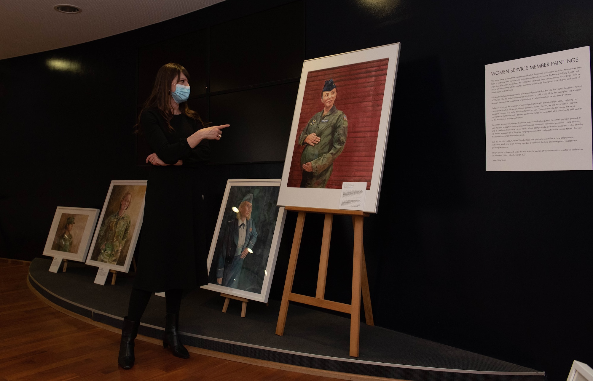 Woman kneels in front of painting
