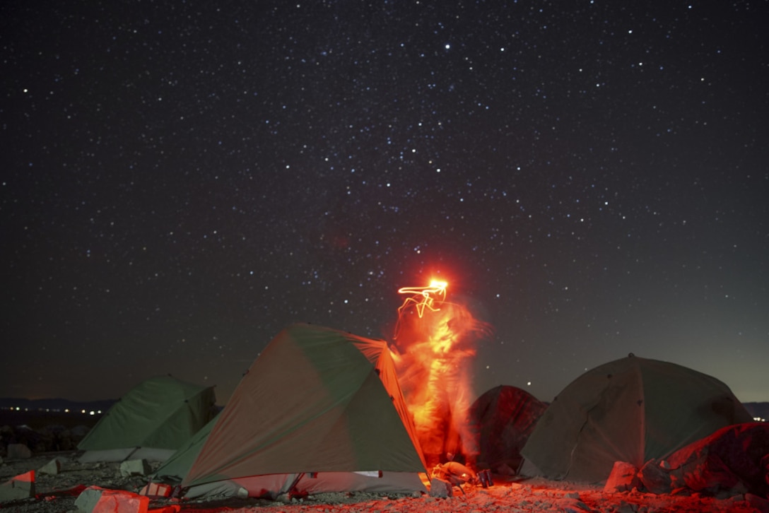 A U.S. Marine with Charlie Company, Battalion Landing Team 1/1, 11th Marine Expeditionary Unit, stages gear before a night range during Realistic Urban Training exercise at Marine Corps Air Ground Combat Center Twentynine Palms, California, Mar. 1, 2021.