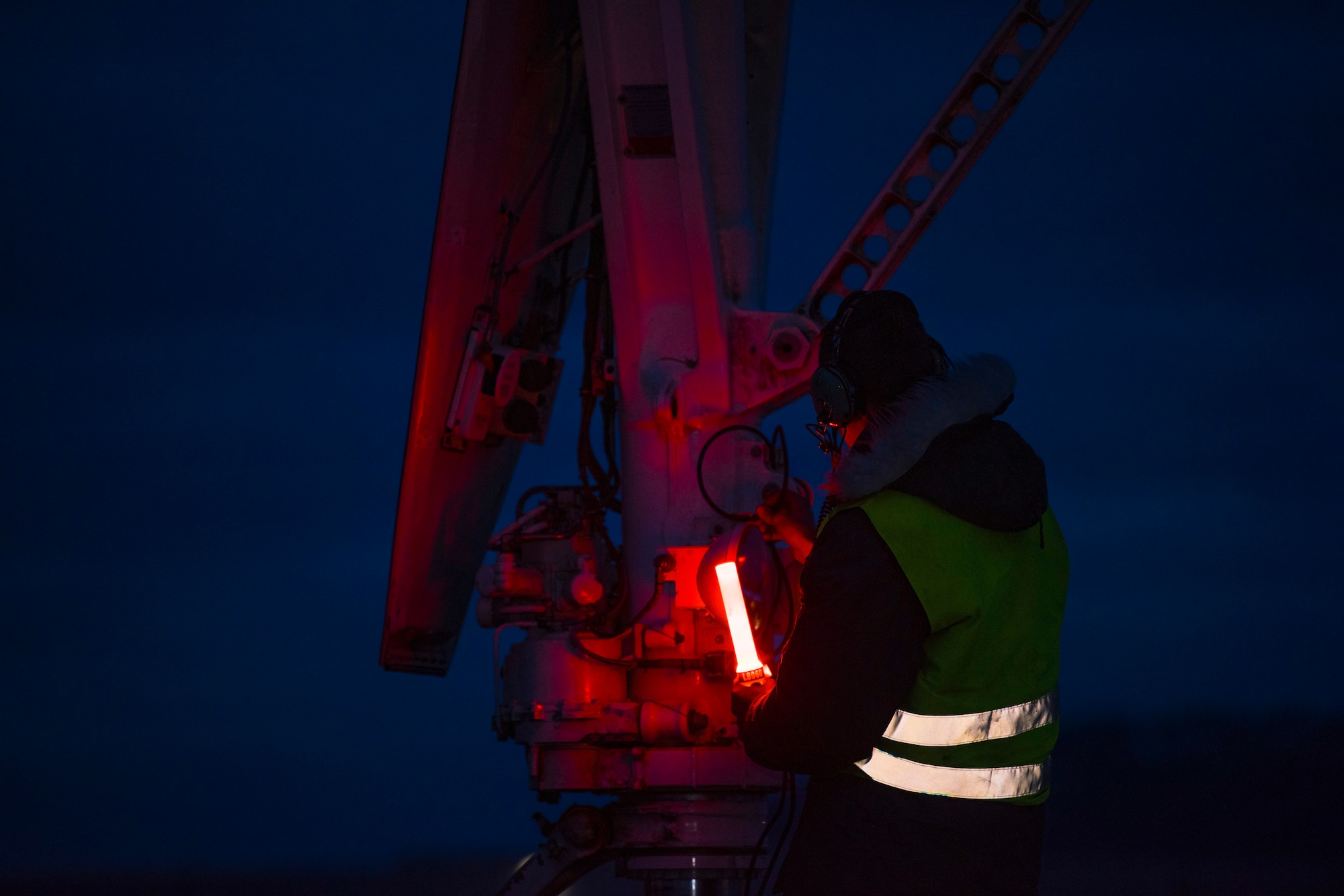 A crew chief assigned to the 9th Expeditionary Bomb Squadron plugs a headset into a B-1B Lancer at Ørland Air Force Station, Norway, March 12, 2021. During Spring Spear, a Bomber Task Force Europe training mission, the B-1 aircrew integrated with Swedish, Danish, and Polish fighters and U.S. Marine and Norwegian Joint Terminal Attack Controllers. (U.S. Air Force photo by Airman 1st Class Colin Hollowell)