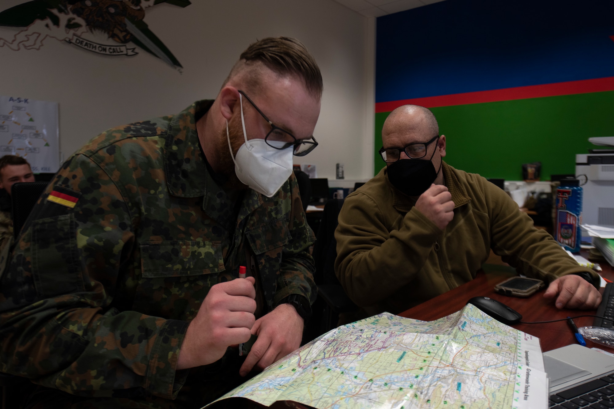 An Airman talks with a member of the German armed forces.