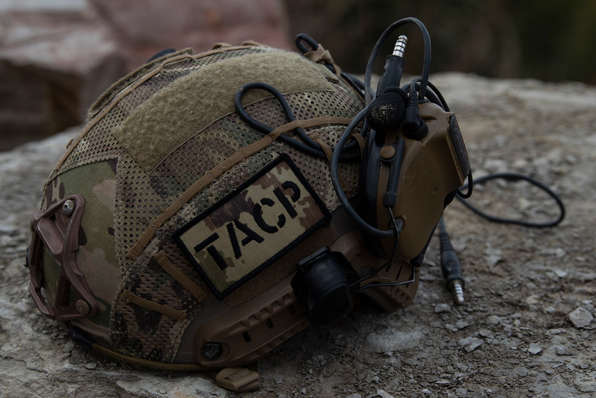 A helmet rests on a rock.