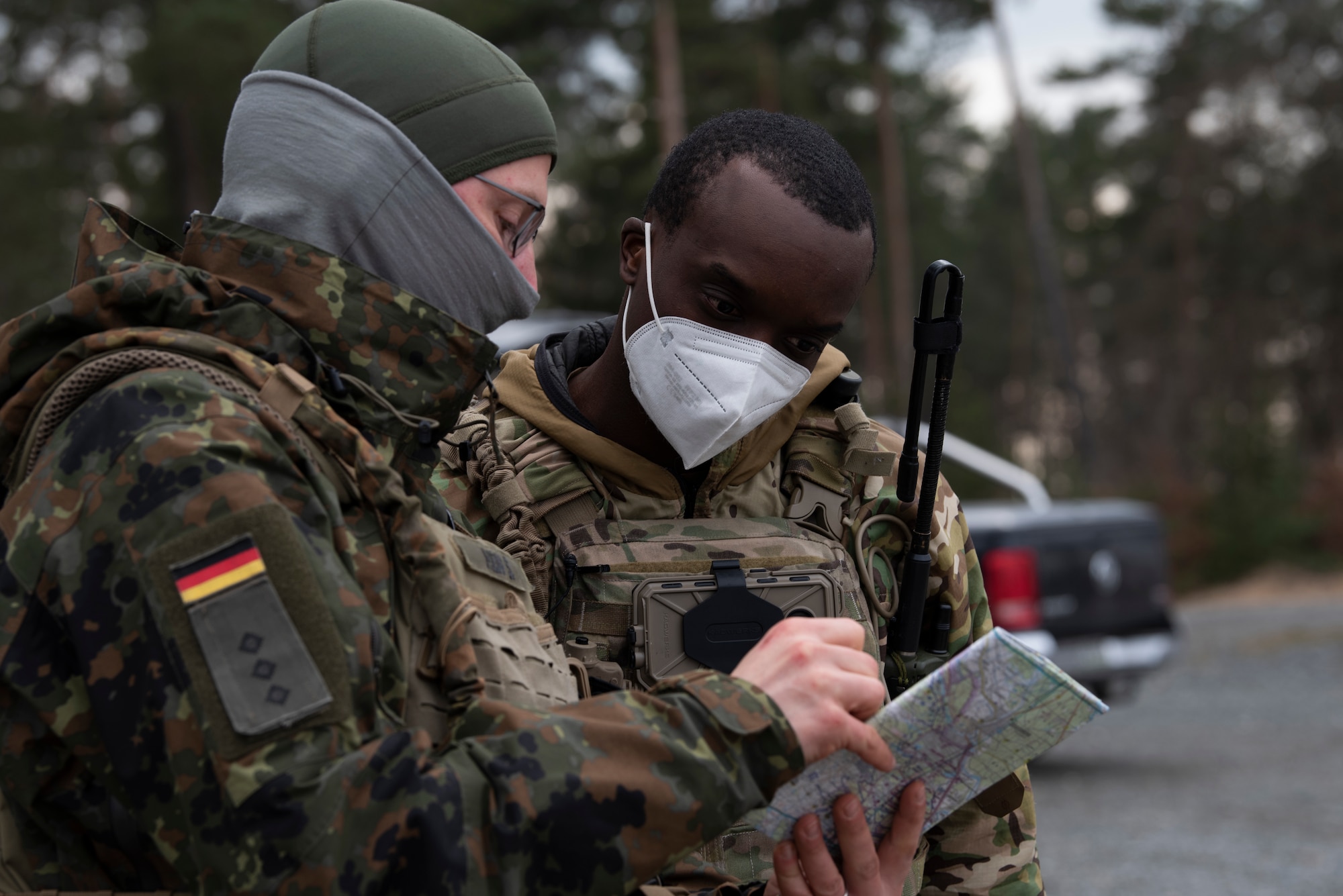 An Airman speajs with a member of the German armed forces.
