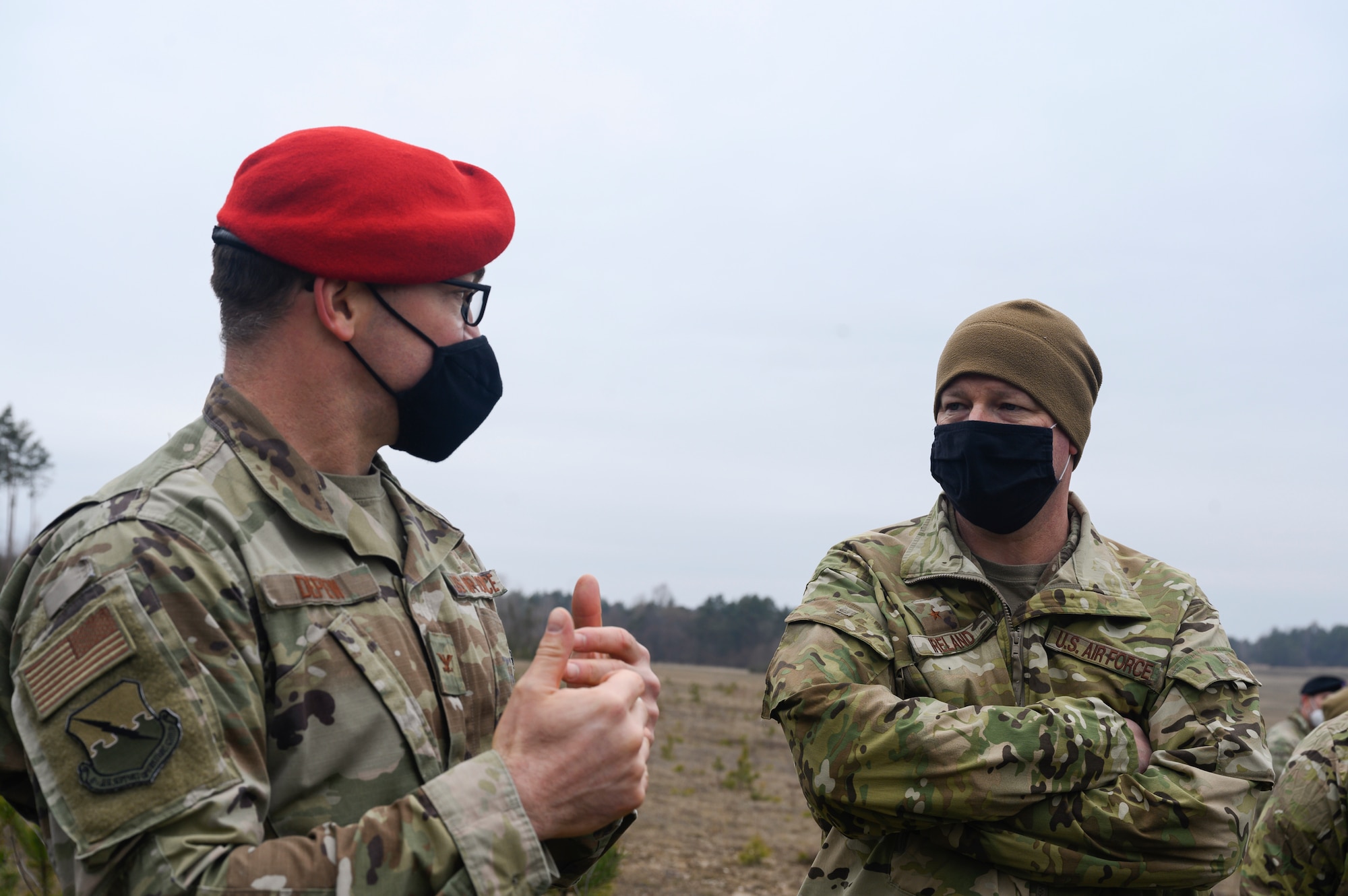 Two Airman speak with each other.