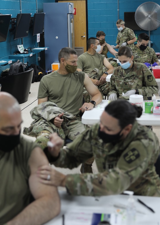 Soldiers received the Janssen COVID-19 vaccine at the March 13, 2021 rollout of Operation Med Spear at Camp Arifjan, Kuwait, from medical Soldiers deployed to the camp with the Army Reserve's 228th Combat Support Hospital. The Janssen vaccine was approved for use by the Food and Drug Administration Feb. 27, 2021 and is already in theater for wide distribution. (U.S. Army photo by Staff Sgt. Neil W. McCabe)
