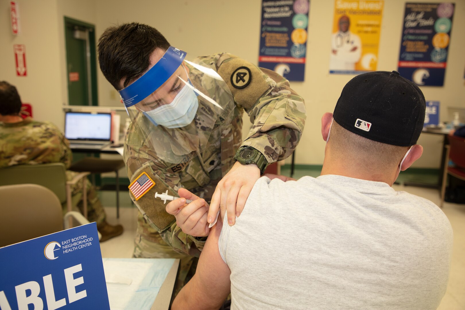 Medical professionals from the Massachusetts National Guard administer COVID vaccines to members of the community at the East Boston Neighborhood Health Center, March 1, 2021.