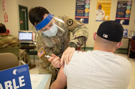 Medical professionals from the Massachusetts National Guard administer COVID vaccines to members of the community at the East Boston Neighborhood Health Center, March 1, 2021.