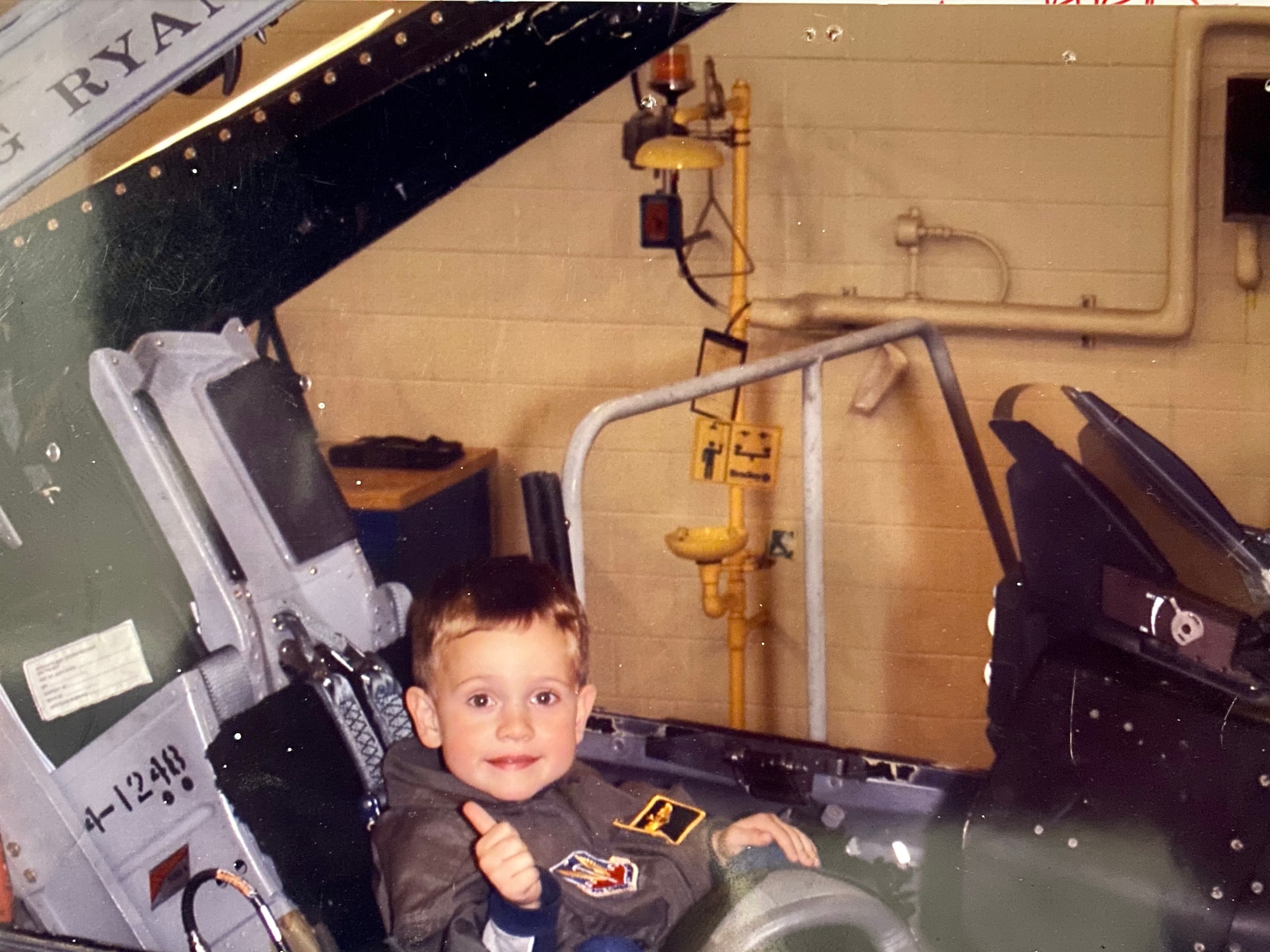 Joey Gigliotti poses for a photo in the cockpit of an F-16 Fighting Falcon during a Family Day event at the 148th Fighter Wing. Gigliotti is the third generation of his family to serve in the Air National Guard. (Courtesy Photo)