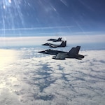 NORAD CF-18s and F-15s conduct a northern air defense patrol over the Beaufort Sea during exercise AMALGAM DART that ran from August 17-21.