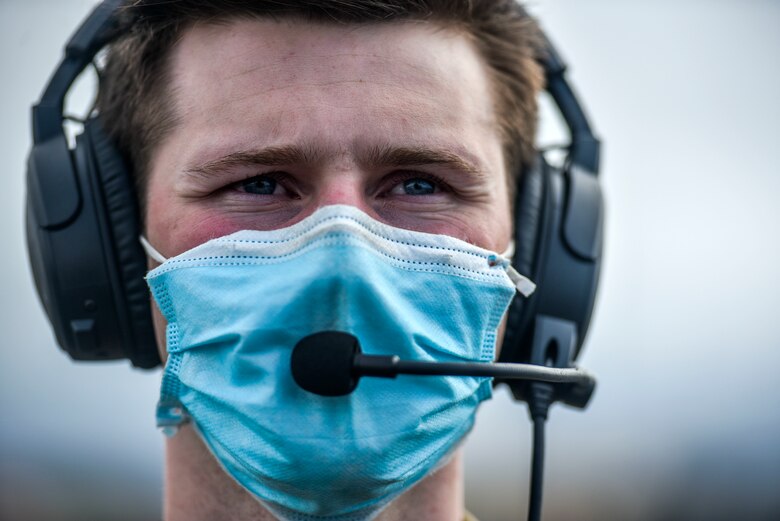 Airman 1st Class Andrew Girard, 535th Airlift Squadron loadmaster, communicates with C-17 Globemaster III pilots before conducting a mission during Exercise TROPIC FURY at Joint Base Pearl Harbour-HIckam, March 12, 2021. Exercise TROPIC FURY demonstrated the 15th Wing’s No. 1 priority, ready now, a key to sustaining operations through the COVID-19 pandemic. (U.S. Air Force photo by Tech. Sgt. Anthony Nelson Jr. )