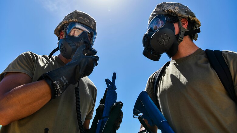 647th Civil Engineer Squadron Airmen discuss mission protocol during Exercise TROPIC FURY at Joint Base Pearl Harbor-Hickam, Hawaii, March 12, 2021. The 15th Wing prepared to generate and deploy combat power from JBPHH, but is ready to receive, stage and enable onward movement of follow-on forces. (U.S. Air Force photo by Tech. Sgt. Anthony Nelson Jr.)