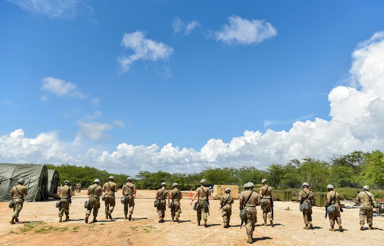 647th Civil Engineer Squadron Airmen return to their stations before executing a Mission Oriented Protective Posture 4 during a chemical, biological, radiological, or nuclear drill during Exercise TROPIC FURY at Joint Base Pearl Harbor-Hickam, Hawaii, March 12, 2021. The 15th Wing prepared to generate and deploy combat power from JBPHH, but is ready to receive, stage and enable onward movement of follow-on forces. (U.S. Air Force photo by Tech. Sgt. Anthony Nelson Jr.)