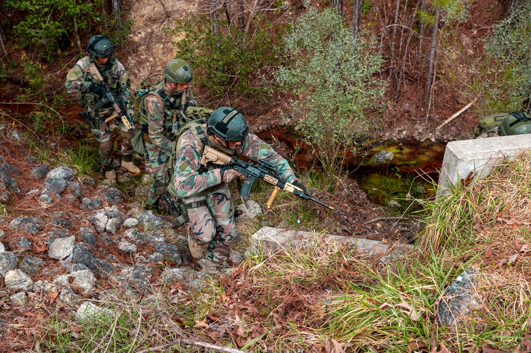 Dutch Marines with 32nd Raiding Squadron advance to the next objective during Exercise Caribbean Urban Warrior on Camp Lejeune, N.C., March 15, 2021. The exercise is a bilateral training evolution designed to increase global interoperability between 2d Reconnaissance Battalion, 2d Marine Division and 32nd Raiding Squadron, Netherlands Marine Corps. (U.S. Marine Corps photo by Lance Cpl. Jacqueline Parsons)