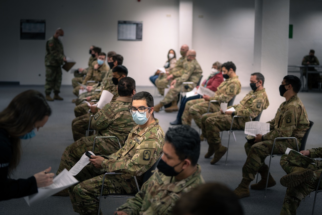 Soldiers are briefed before receiving the COVID-19 vaccine.