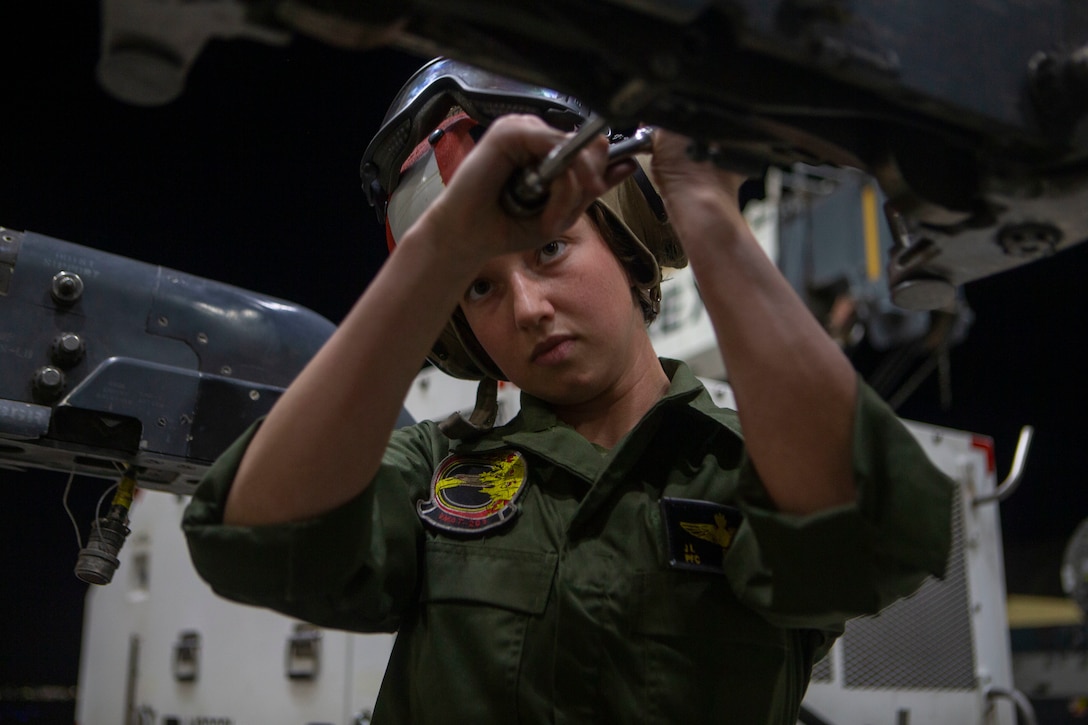 Private First Class JennaMarie Drinkwater, an aircraft ordnance technician,  disassembles the part of wing that hold the ordnance of the AV- 8B Harrier II at Marine Corps Air Station Yuma, Arizona, January 21, 2021.