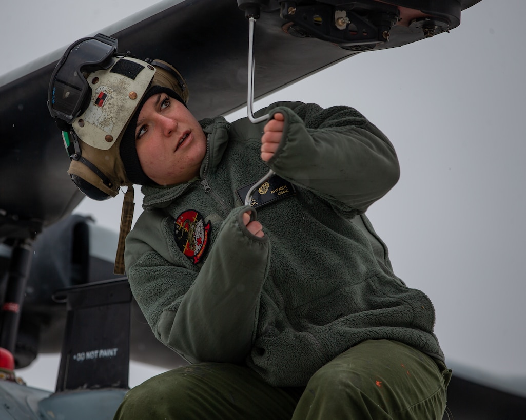 Cpl. Lydia C. Rhyner, a helicopter airframe mechanic, tightens an AH-1Z Viper’s rotor safety bolt at Alpena Combat Readiness Training Center, Michigan, January 23, 2021.