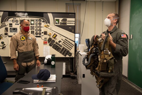 201019-N-OU681-1050 CORPUS CHRISTI, Texas (Oct. 19, 2020) Aerospace Physiologist Lt. Chris Greil teaches Ens. Anthony Seuga-Duncan, student naval aviator, survival procedures at Training Air Wing 4 aboard Naval Air Station Corpus Christi, Oct. 19. Greil was named the 2020 Chief of Naval Air Training AMSO of the Year and received the 2020 Military Health Systems (MHS) and Allied Health Excellence Leadership award. (U.S. Navy photo by Lt. Michelle Tucker/Released)