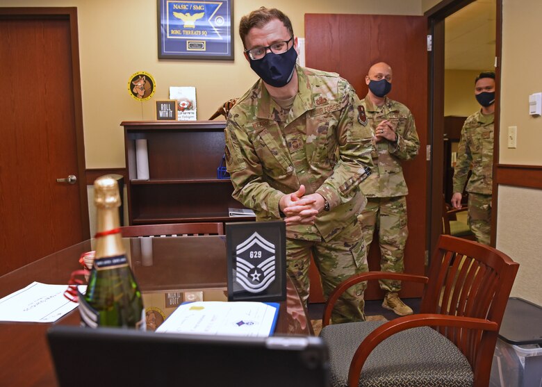 U.S. Air Force Senior Master Sgt. David Weaver, 17th Training Wing, Comptroller Squadron and Wing Staff Agencies superintendent, congratulates the virtually present Master Sgt. Erica Pratt, 17th Training Group operations superintendent, on Pratt’s selection for promotion, in the Norma Brown building on Goodfellow Air Force Base, Texas, March 15, 2021.  Additional members brought to life the concept of ‘hashtag we are Goodfellow’ (#WeAreGoodfellow) when they virtually congratulated Pratt on her achievement; this signified how out of sight, didn’t mean out of mind for Team Goodfellow. (U.S. Air Force photo by Senior Airman Abbey Rieves)
