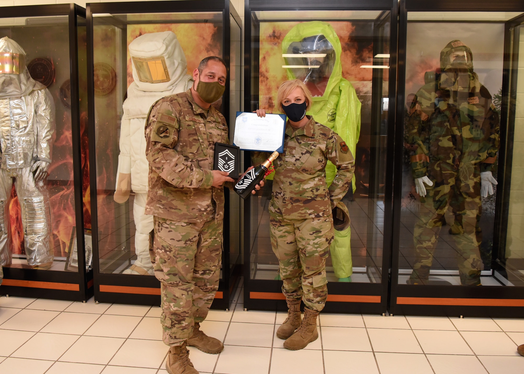 U.S. Air Force Master Sgt. Kevin Johnson, 312th Training Squadron first sergeant, receives his selectee notification for promotion to Senior Master Sgt. from Chief Master Sgt. Casey Boomershine, 17th Training Wing command chief, in the 312th TRS schoolhouse, on Goodfellow Air Force Base, Texas, March 15, 2021. Johnson’s line number was eight, which indicates when he will officially promote to the rank he earned. (U.S. Air Force photo by Senior Airman Abbey Rieves)