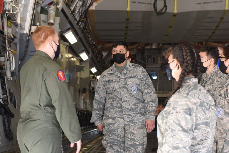 U.S. Air Force Staff Sgt. Austin Bennett, 58th Airlift Squadron C-17 Globemaster III  loadmaster instructor, answers questions from Air Force Junior Reserve Officers' Training Corps (AFJROTC) cadets at Altus Air Force Base, Oklahoma, March 12, 2021. The AFJROTC cadets visited the base to tour various places to learn more about the U.S. Air Force. (U.S. Air Force photo by 2nd Lt. Cameron Silver)
