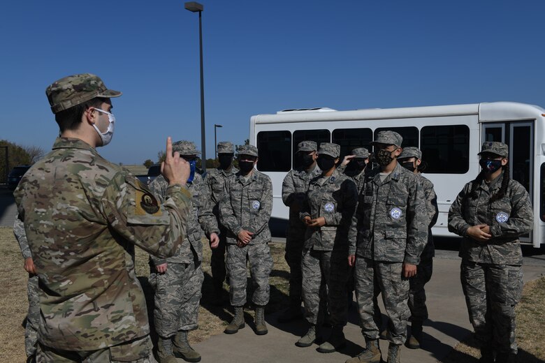 U.S. Air Force Staff Sgt. Jacob Graham, 97th Operations Support Squadron air traffic controller apprentice, explains the operations of the control tower to Air Force Junior Reserve Officers' Training Corps (AFJROTC) cadets at Altus Air Force Base (AFB), Oklahoma, March 10, 2021. AFJROTC cadets travelled from Southeast High School, Oklahoma City, to tour Altus AFB. (U.S. Air Force photo by Airman 1st Class Kayla Christenson)