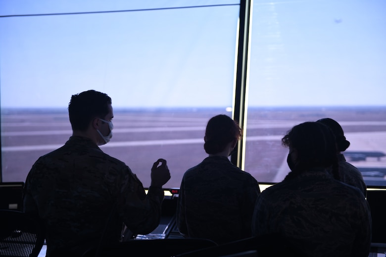 U.S. Air Force Staff Sgt. Jacob Graham, 97th Operations Support Squadron air traffic controller apprentice, answers questions from Air Force Junior Reserve Officers' Training Corps (AFJROTC) cadets in the control tower at Altus Air Force Base, Oklahoma, March 10, 2021. AFJROTC cadets toured the base to learn about how we train exceptional mobility Airmen and witness first-hand an active duty installation. (U.S. Air Force photo by Airman 1st Class Kayla Christenson)