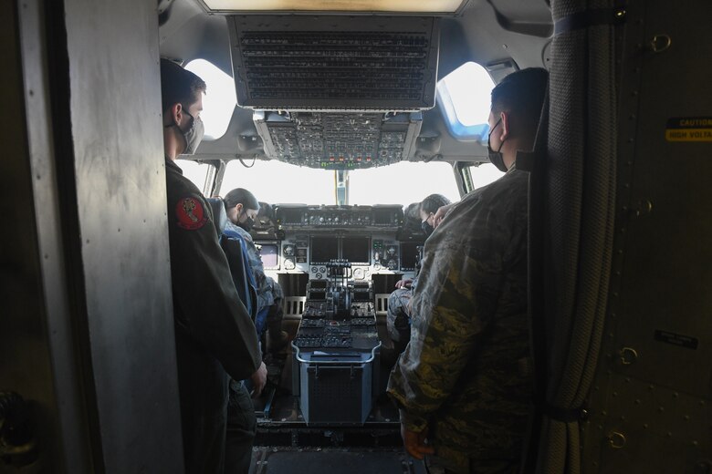 U.S. Air Force Capt. Alexander Hoffman, 58th Airlift Squadron C-17 Globemaster III pilot, shows the C-17 cockpit to Air Force Junior Reserve Officers' Training Corps (AFJROTC) cadets at Altus Air Force Base, Oklahoma, March 10, 2021. The AFJROTC students toured the control tower, a C-17 Globemaster III, witnessed a Military Working Dog demonstration and then finished off the day at the Hangar 97 dining facility for lunch. (U.S. Air Force photo by Airman 1st Class Kayla Christenson)