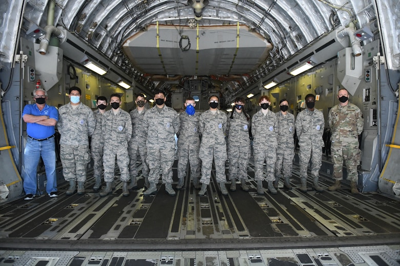Air Force Junior Reserve Officers' Training Corps (AFJROTC) cadets pose for a group photo on a C-17 Globemaster III, at Altus Air Force Base (AFB), Oklahoma, March 10, 2021. The C-17 is capable of rapid strategic delivery of troops and all types of cargo to main operating bases or directly to forward bases in the deployment area. (U.S. Air Force photo by Airman 1st Class Kayla Christenson)