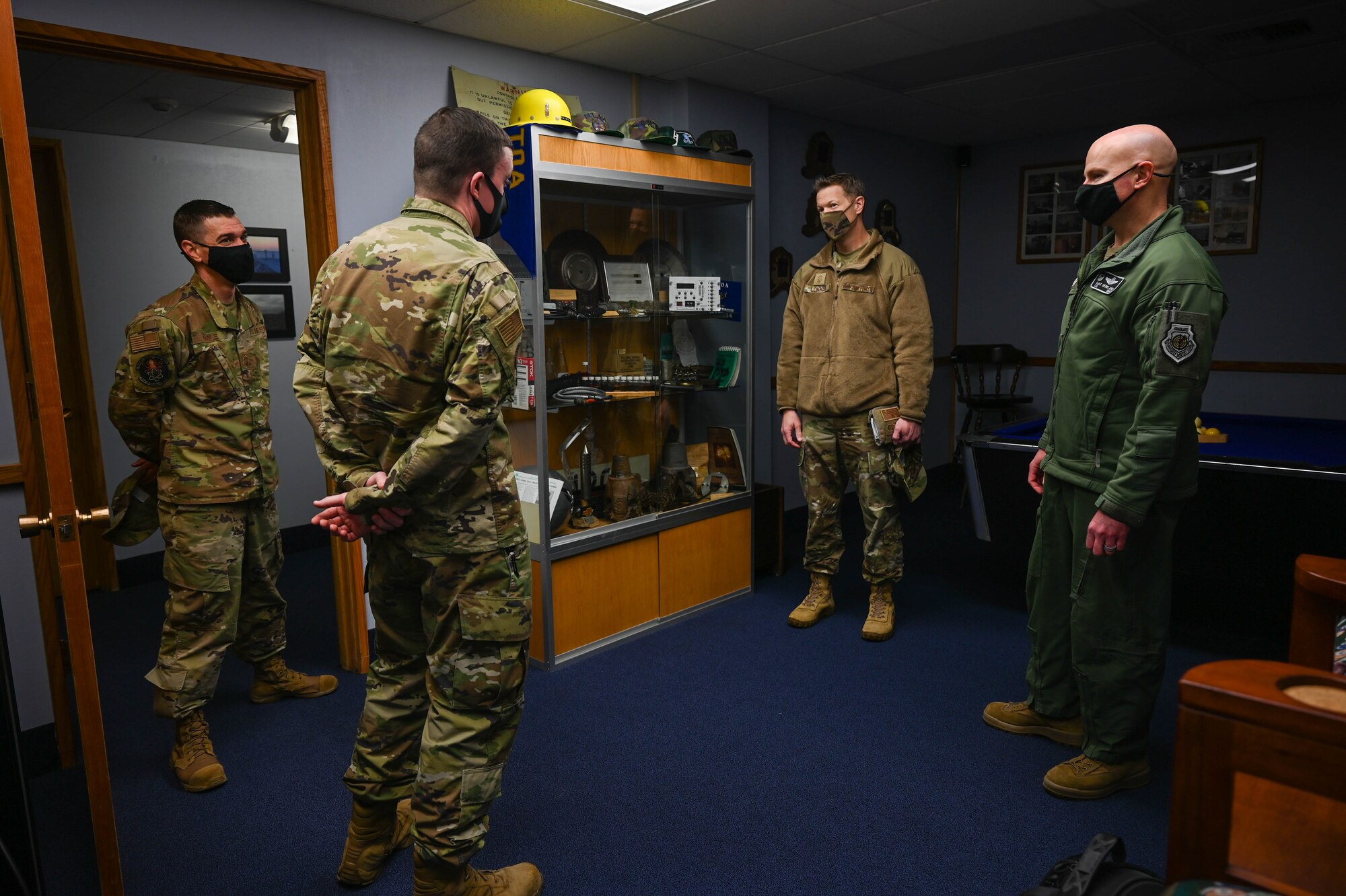 U.S. Air Force Senior Master Sgt. Aaron Boyle, left, the 709th Technical Maintenance Squadron (TMXS), Detachment 460 chief, and Staff Sgt. Robert Stone, a 709th TMXS field maintenance supervisor, speak with Chief Master Sgt. John Lokken, the 354th Fighter Wing (FW) command chief, and Col. David Berkland, the 354th FW commander, during a leadership immersion on Eielson Air Force Base, Alaska, March 11, 2021.