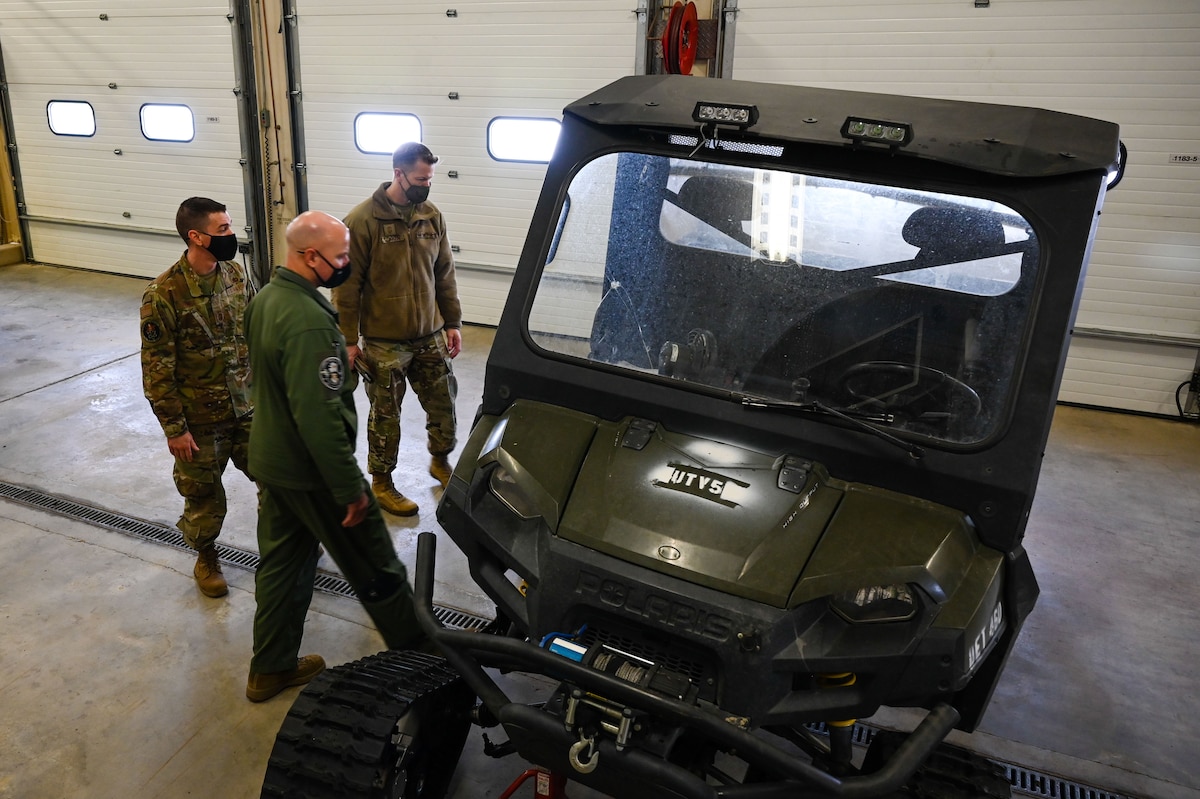 U.S. Air Force Senior Master Sgt. Aaron Boyle, left, the 709th Technical Maintenance Squadron (TMXS), Detachment 460 chief, shows a Utility Transport Vehicle to Col. David Berkland, the 354th Fighter Wing (FW) commander, and Chief Master Sgt. John Lokken, the 354th FW command chief, during a leadership immersion on Eielson Air Force Base, Alaska, March 11, 2021.