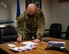 U.S. Air Force Col. David Berkland, the 354th Fighter Wing commander, signs the Air Force Assistance Fund (AFAF) campaign memorandum, on Eielson Air Force Base, Alaska, March 15, 2021.