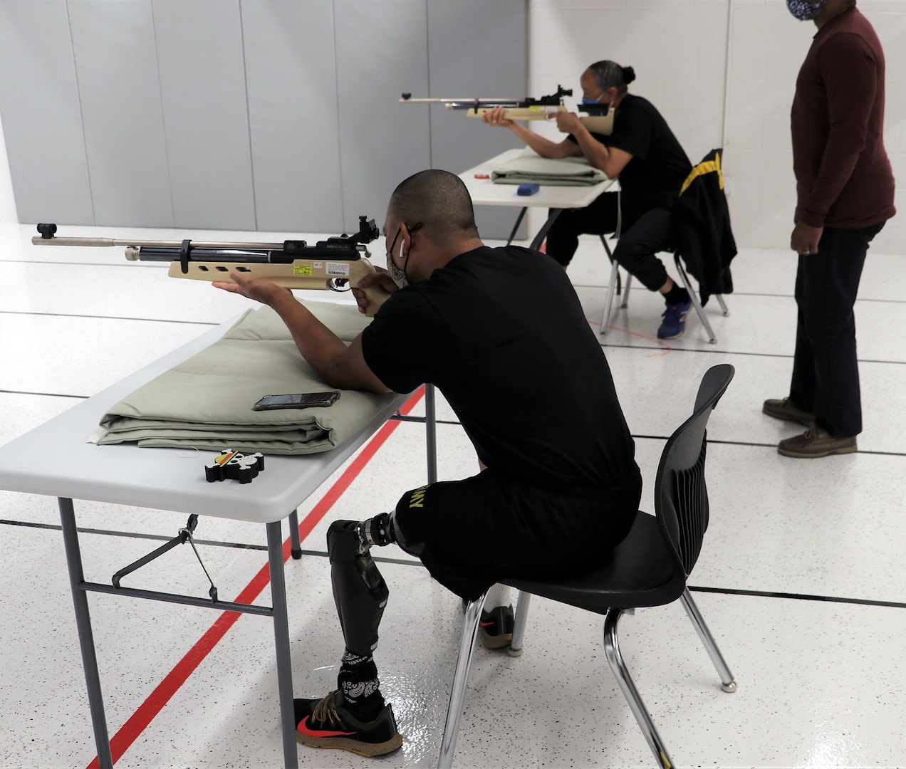 U.S. Army Staff Sgt. Gene Calantoc and Master Sgt. Mary Jackson, Soldier Recovery Unit, Brooke Army Medical Center, shoot for record during the Virtual Army Trials air rifle event at Cole High School at Joint Base San Antonio-Fort Sam Houston March 4. Calantoc and Jackson are among several other BAMC SRU Soldiers vying for selection to Team Army to compete in the DoD Warrior Games in September.