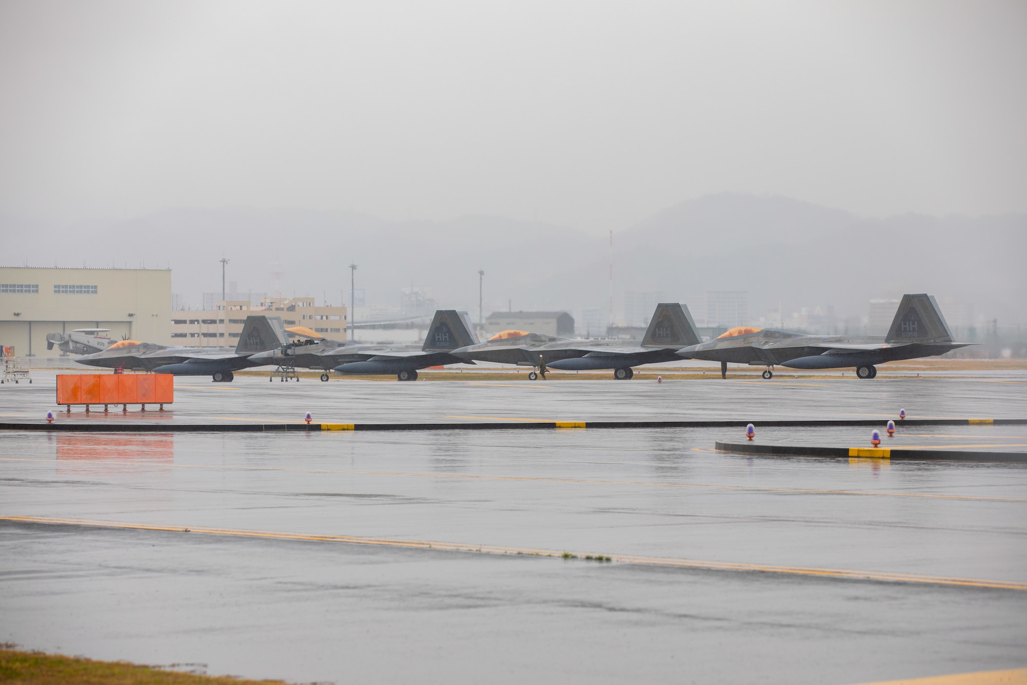 A U.S. Air Force F-22 Raptors with the 199th Fighter Squadron sit on the flight line at Marine Corps Air Station Iwakuni, Japan, March 12, 2021. Airmen with the 199th Fighter Squadron and the 19th Fighter Squadron, based out of Joint Base Pearl Harbor-Hickam, Hawaii, deployed to MCAS Iwakuni to conduct local area training with U.S. Marine Corps units. Pacific Air Forces’ fighters stand ready to support the global strategic environment as it continues to demand flexibility and freedom of action. The Dynamic Force Employment concept will change the way the Department of Defense uses the joint force with its focus on strategic predictability and operational unpredictability. (U.S. Marine Corps photo by Lance Cpl. Triton Lai)